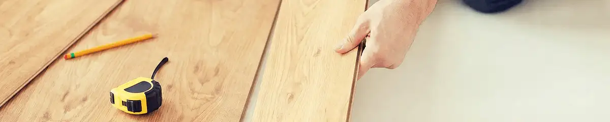 A professional installing wood flooring in Huntsville, AL