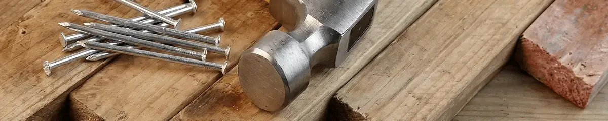 Hammer and nails on hardwood flooring boards in Huntsville, AL