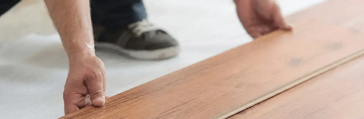 A professional installing laminate flooring in Huntsville, AL