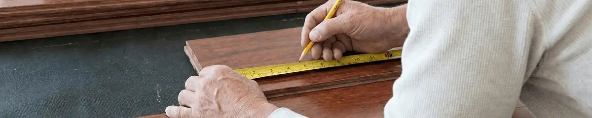 A professional installing wood flooring in Huntsville, AL